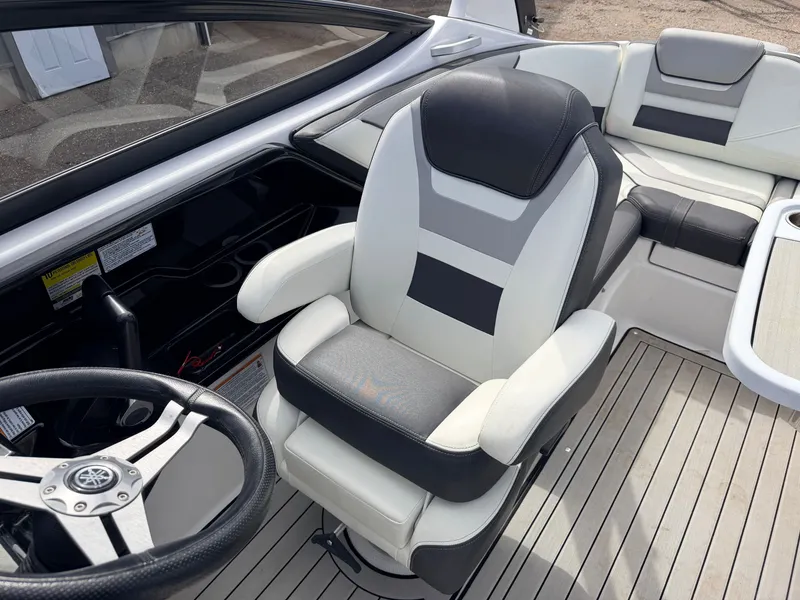Slide: The Image of Interior of a 2020 Yamaha 212S Jet Boat with comfortable seating and steering wheel. - 26