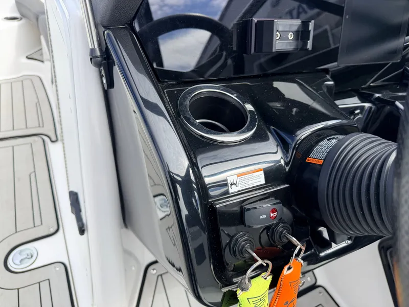 Slide: The Image of Yamaha 212S Jet Boat 2020, console with cup holder and keys. - 31