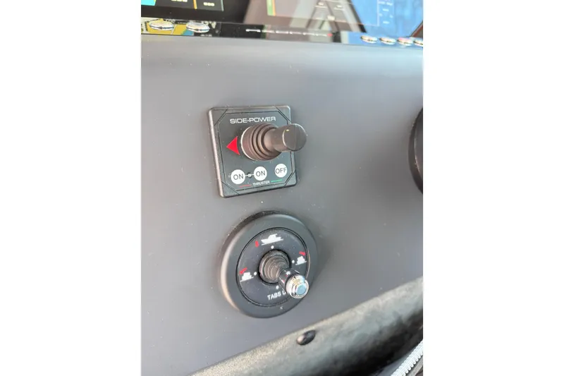 Slide: The Image of Control panel of 2022 Axopar 37 XC Cross Cabin with side-power thruster switches. - 18