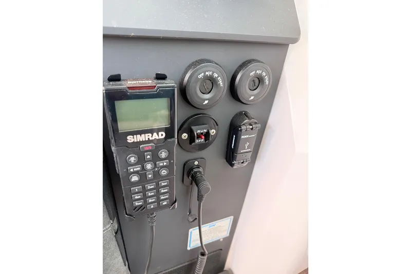 Slide: The Image of Control panel of 2022 Axopar 37 XC Cross Cabin with Simrad device and switches. - 21