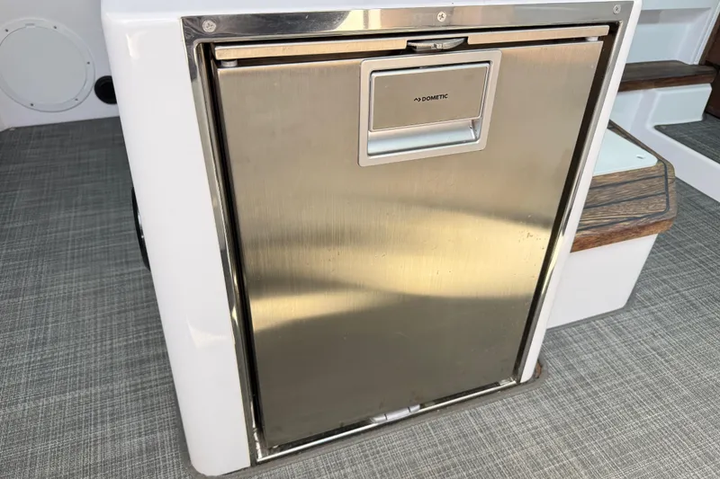 Slide: The Image of Stainless steel Dometic fridge on 2022 Axopar 37 XC Cross Cabin boat interior. - 22