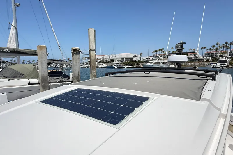 Slide: The Image of 2022 Axopar 37 XC Cross Cabin with solar panel, docked in a marina. - 26
