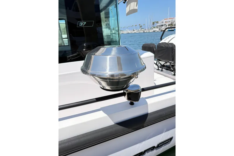 Slide: The Image of 2022 Axopar 37 XC Cross Cabin boat detail with chrome fixture, docked in marina. - 30