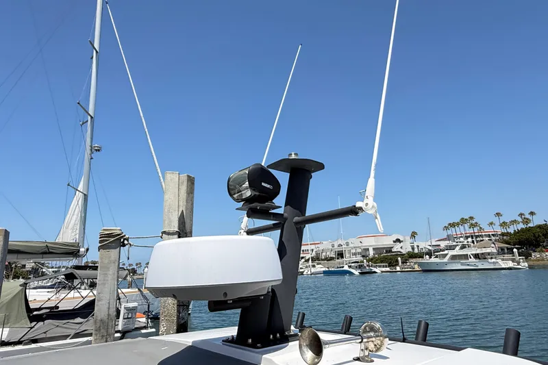 Slide: The Image of 2022 Axopar 37 XC Cross Cabin radar and antennas at marina. - 6