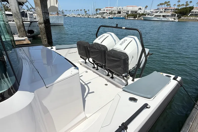Slide: The Image of 2022 Axopar 37 XC Cross Cabin boat docked with twin outboard engines. - 7