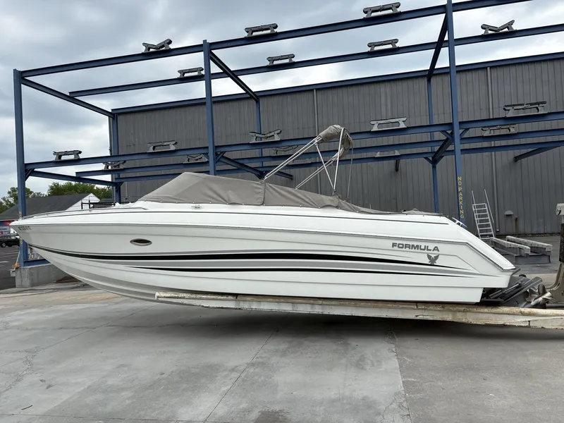 Slide: The Image of 2004 Formula 280 Bow Rider boat on a trailer. - 2