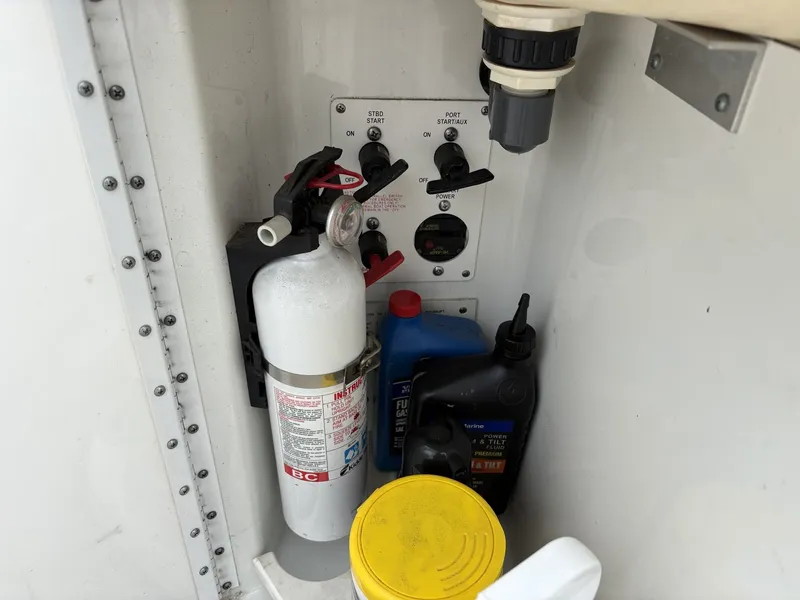 Slide: The Image of Boat controls with fire extinguisher and fluid containers, Formula 280 Bow Rider 2004. - 20