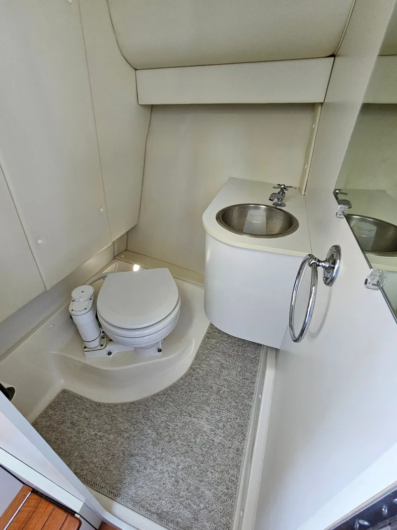 Slide: The Image of 1997 Tiara Yachts 2900 Coronet bathroom with toilet and sink. - 13