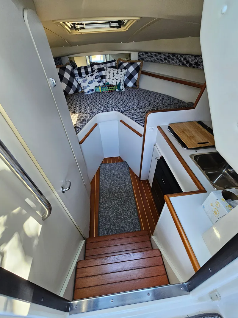 Slide: The Image of Interior of a 1997 Tiara Yachts 2900 Coronet with kitchen and sleeping area. - 4