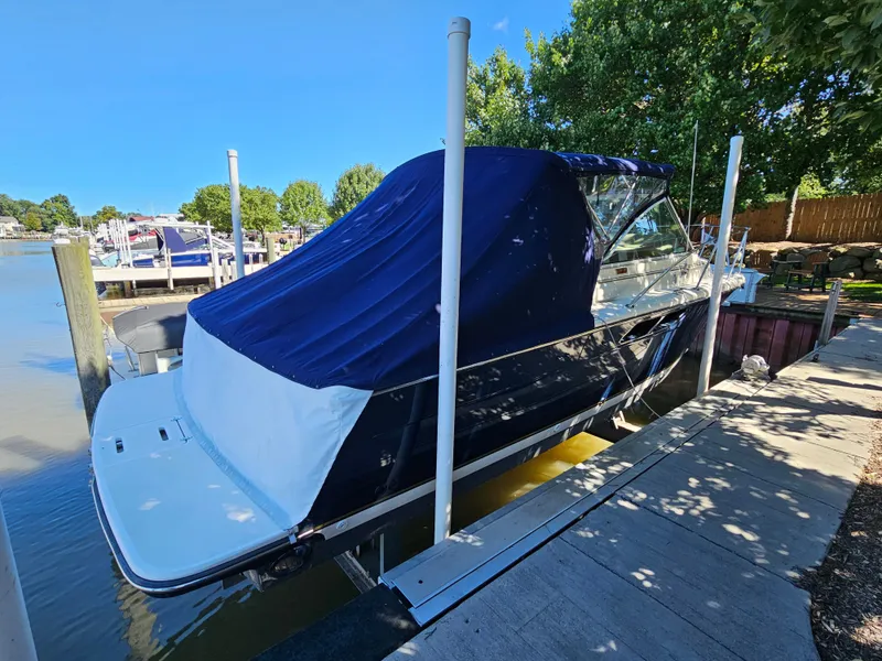Slide: The Image of 1997 Tiara Yachts 2900 Coronet docked with blue cover. - 7