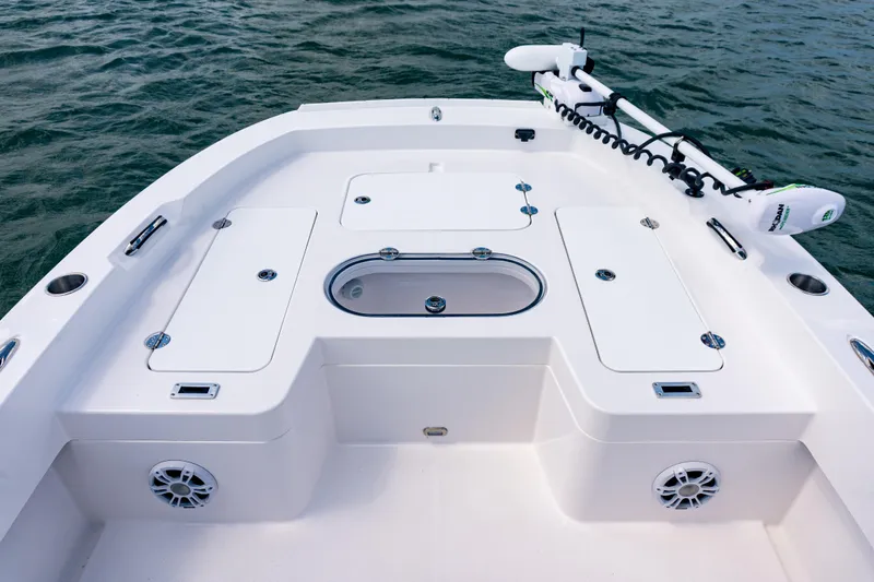 Slide: The Image of 2026 Twin Vee 22 BayCat boat deck with storage compartments and trolling motor. - 11