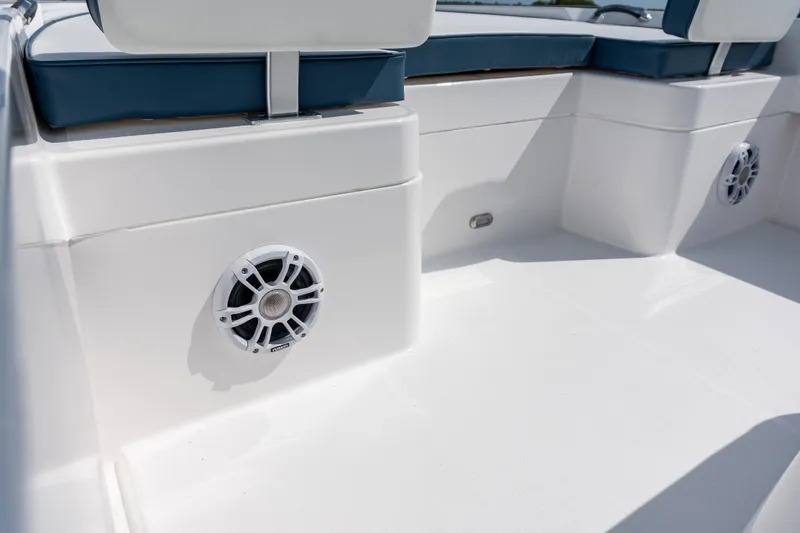 Slide: The Image of 2026 Twin Vee 22 BayCat interior with white speakers and cushioned seating. - 12