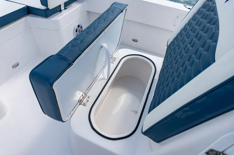 Slide: The Image of 2026 Twin Vee 22 BayCat boat seat with storage compartment open. - 7