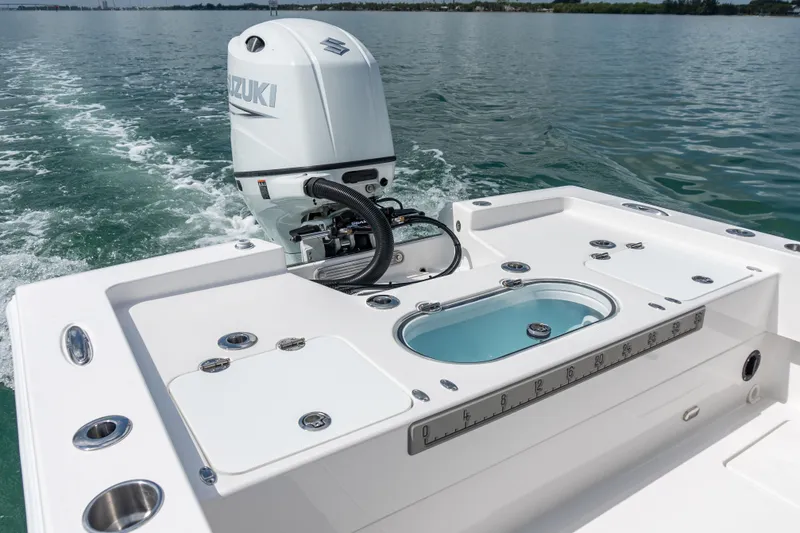 Slide: The Image of 2026 Twin Vee 22 BayCat boat with Suzuki outboard motor on calm water. - 9