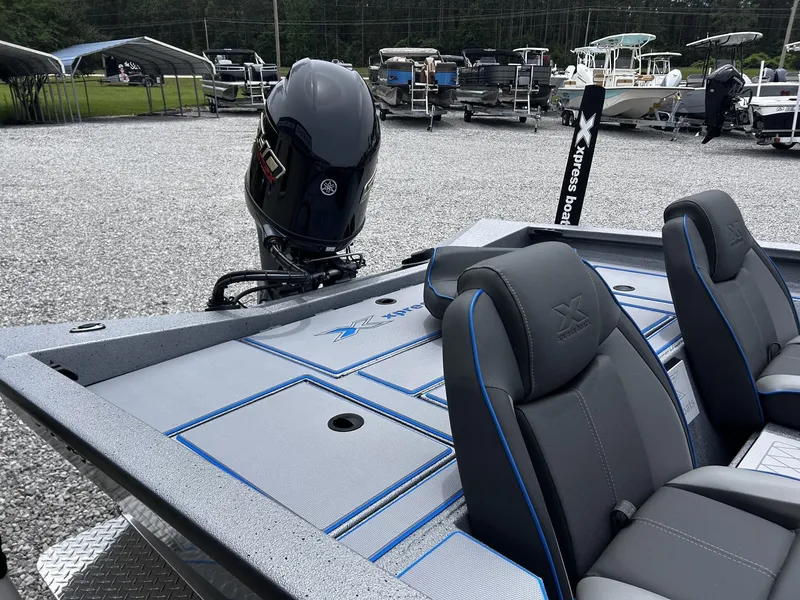 Slide: The Image of 2026 Xpress H17 boat with Yamaha engine on gravel lot. - 11