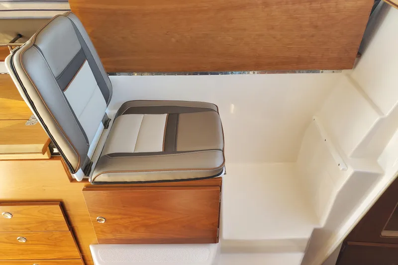 Slide: The Image of 2024 Cutwater C-30 CB interior seat with wood accents and modern design. - 10