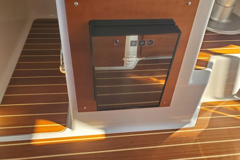 Slide: The Image of 2024 Cutwater C-30 CB boat interior with Koolatron fridge and wooden flooring. - 11