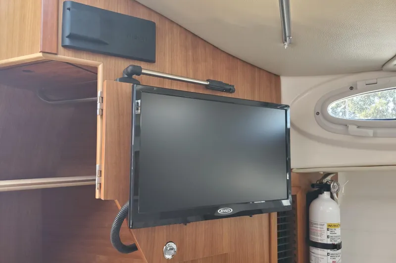 Slide: The Image of 2024 Cutwater C-30 CB interior with mounted TV and fire extinguisher. - 14
