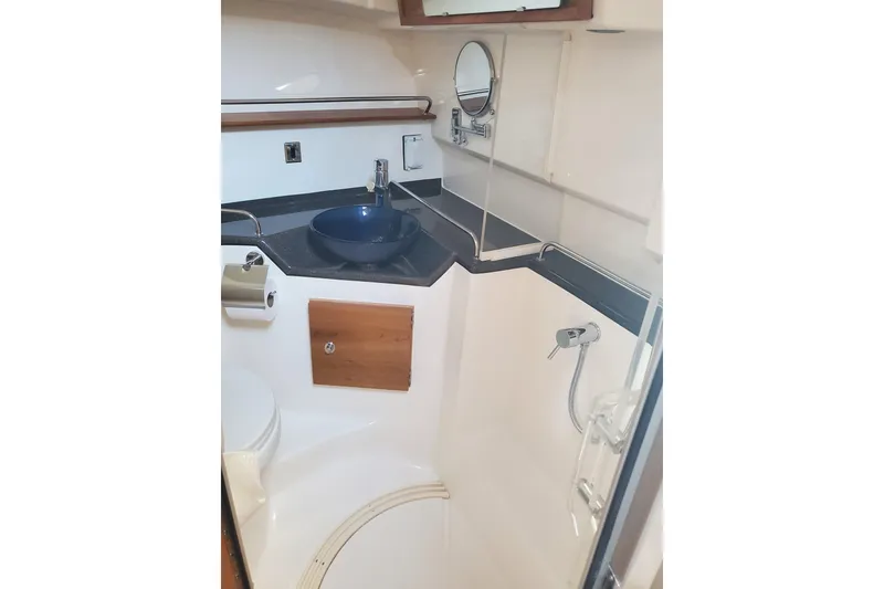 Slide: The Image of 2024 Cutwater C-30 CB boat bathroom with modern sink and shower. - 15