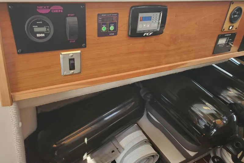 Slide: The Image of Control panel and equipment storage on a 2024 Cutwater C-30 CB boat. - 17