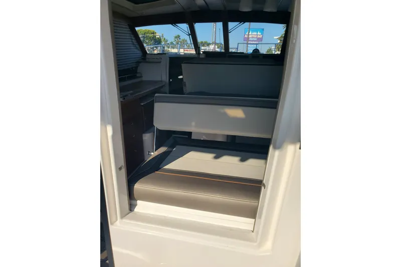 Slide: The Image of 2024 Cutwater C-30 CB interior seating area with window view. - 20