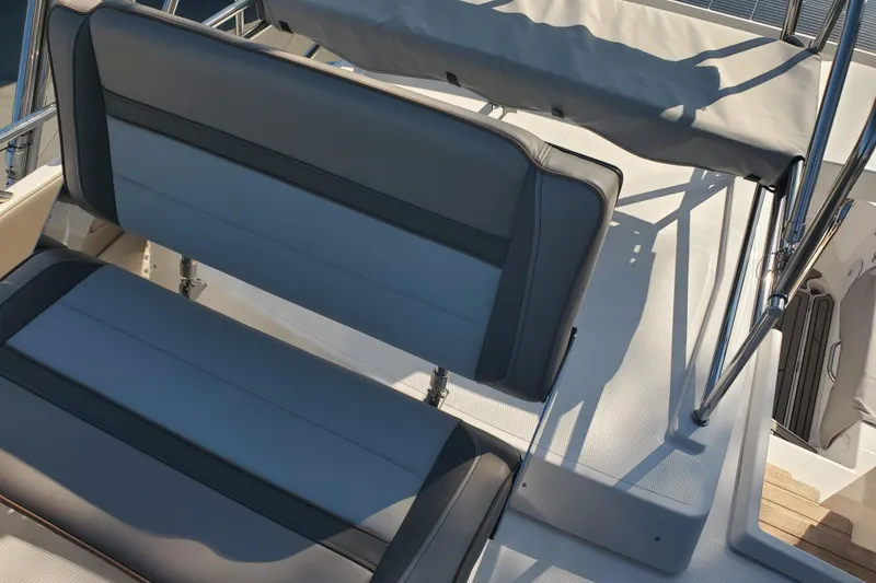Slide: The Image of 2024 Cutwater C-30 CB boat seating area with gray upholstery and stainless steel frame. - 22