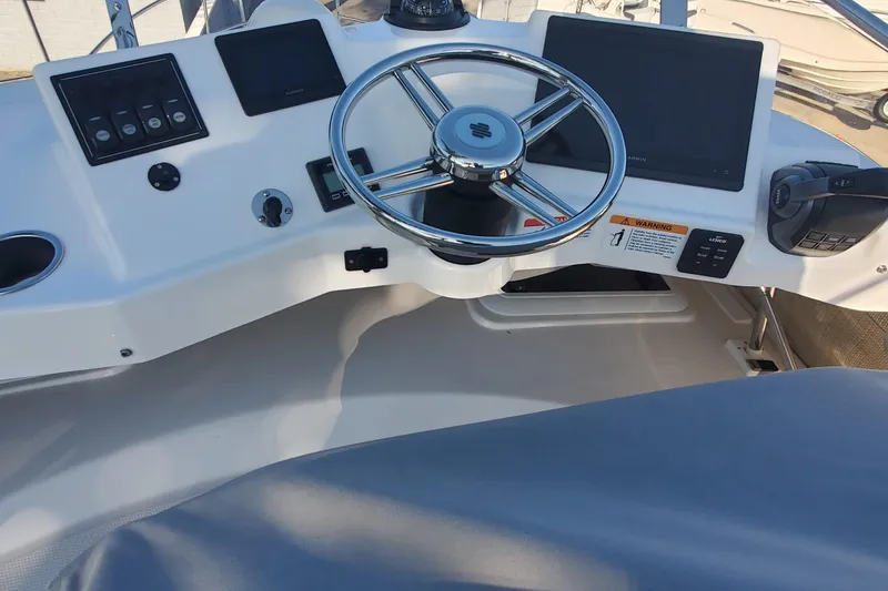 Slide: The Image of 2024 Cutwater C-30 CB helm with steering wheel and navigation screens. - 24