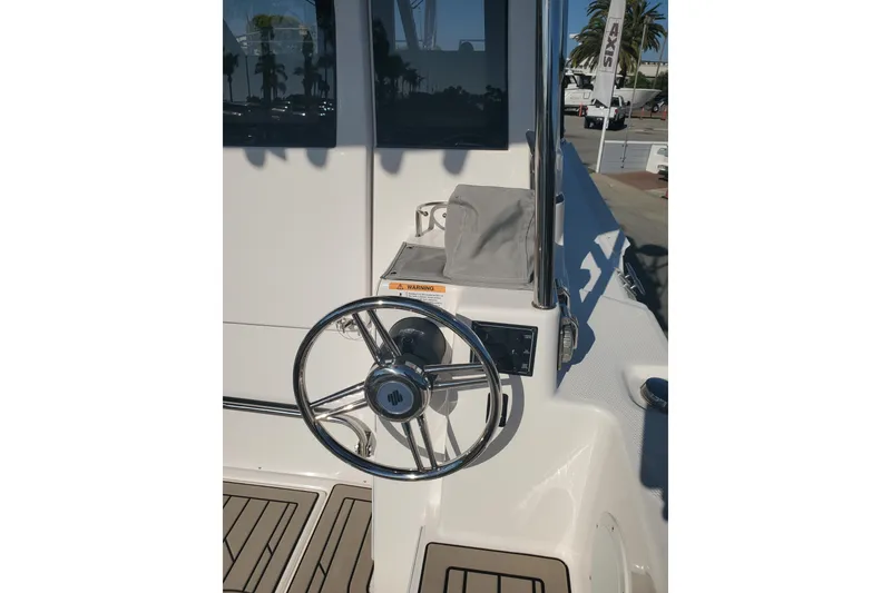 Slide: The Image of 2024 Cutwater C-30 CB boat helm with steering wheel and controls. - 26