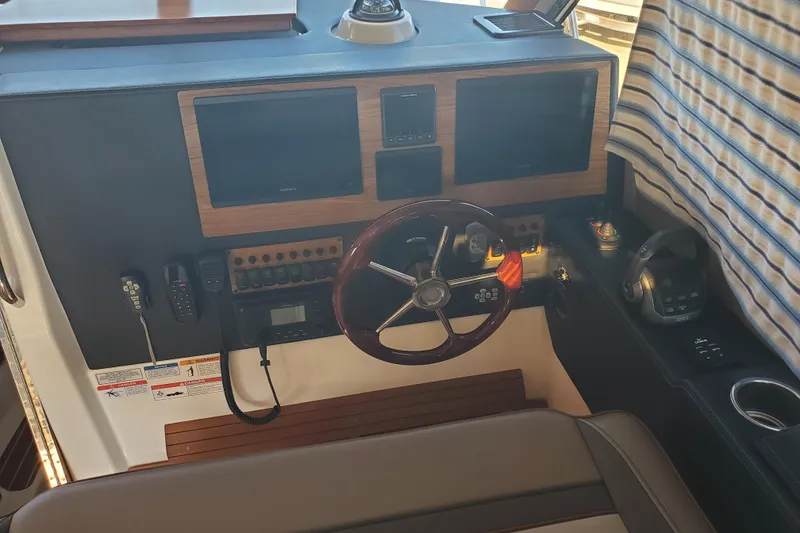 Slide: The Image of 2024 Cutwater C-30 CB helm with dual screens, steering wheel, and control panel. - 3