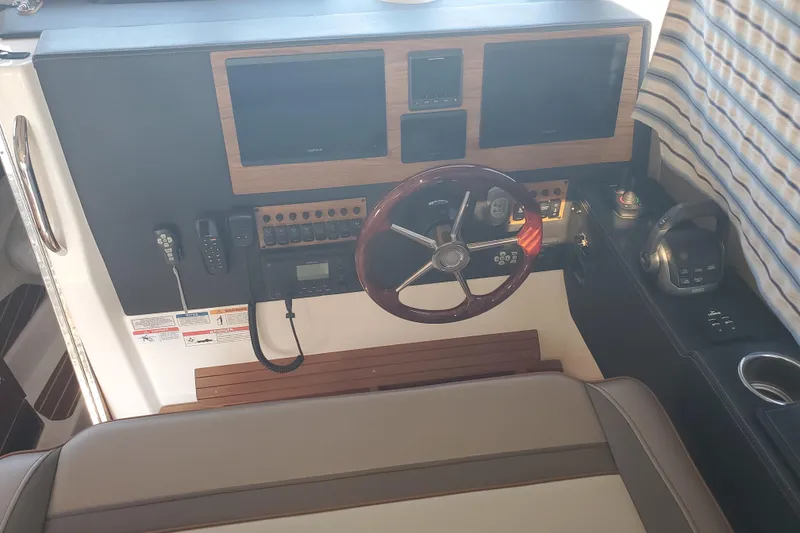 Slide: The Image of 2024 Cutwater C-30 CB helm with steering wheel, controls, and navigation screens. - 4