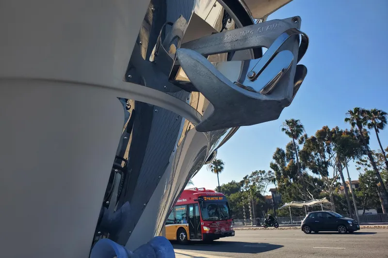 Slide: The Image of 2024 Cutwater C-30 CB boat with anchor, street view, bus, and palm trees. - 41