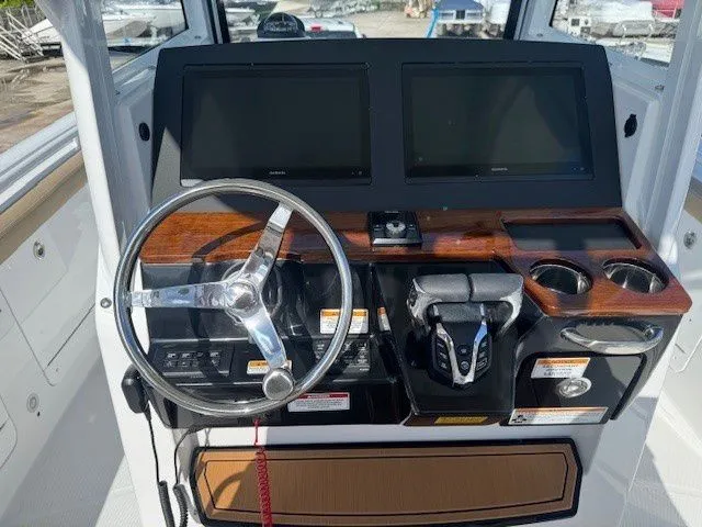 Slide: The Image of Everglades 285 Center Console 2026 helm with dual screens. - 19