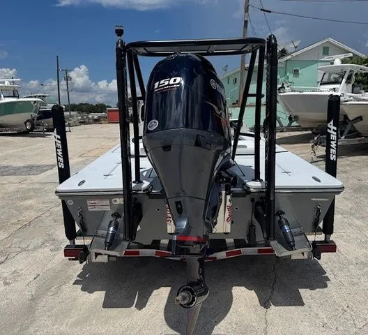 Slide: The Image of Rear view of a 2026 Hewes Redfisher 18 boat with outboard motor. - 48