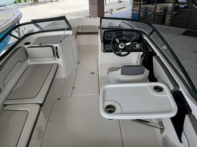 Slide: The Image of Interior of a 2026 Yamaha AR190 boat with steering wheel and table. - 4