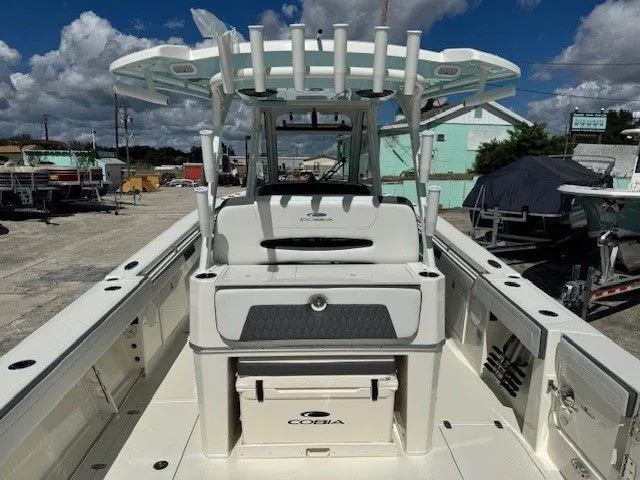 Slide: The Image of 2026 Cobia 305 Center Console boat on a sunny dock. - 47
