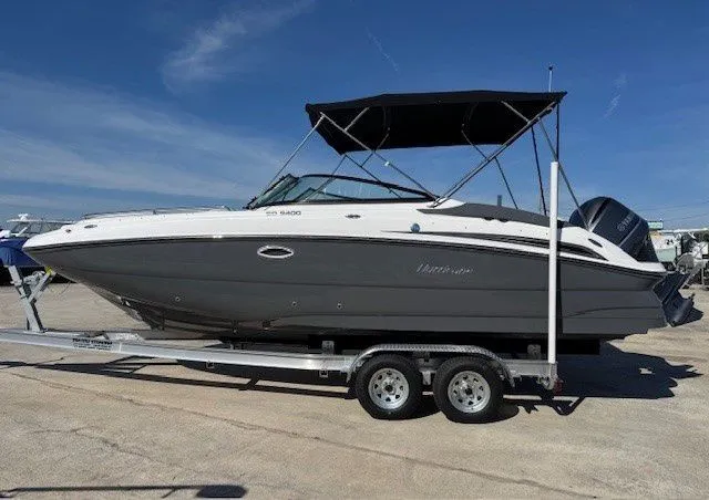 The Image of 2026 Hurricane SunDeck 2400 OB boat on trailer, side view. - 1