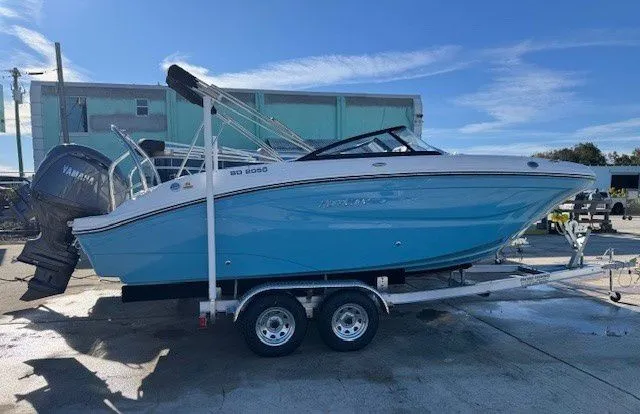 The Image of 2026 Hurricane SunDeck 2050 OB boat on trailer outdoors. - 1