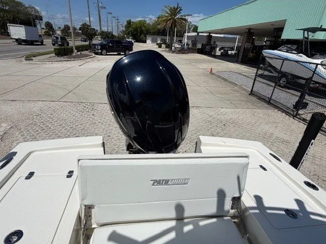 Slide: The Image of 2026 Pathfinder 2200 TRS boat with outboard motor on a parking lot. - 7