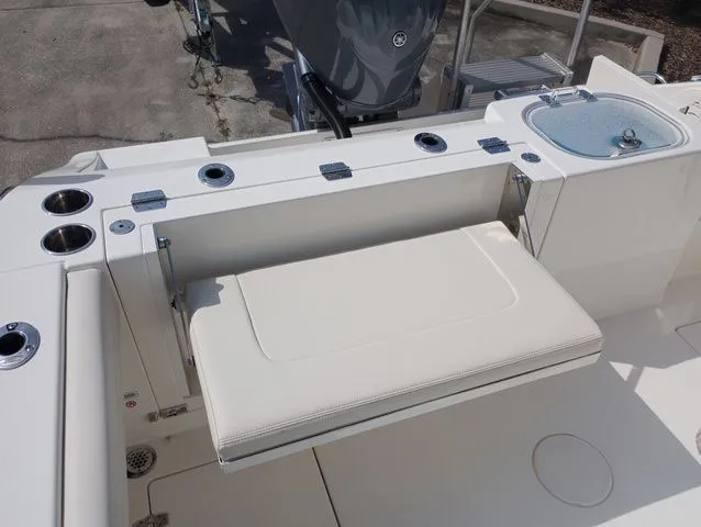 Slide: The Image of 2022 Cobia 240 Center Console with foldable seat and fishing rod holders. - 45