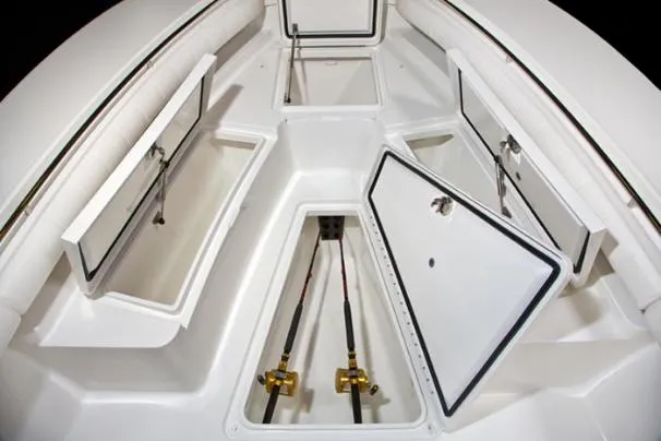 Slide: The Image of 2017 Regulator 28 Forward Seating with open storage compartments and fishing rods. - 4