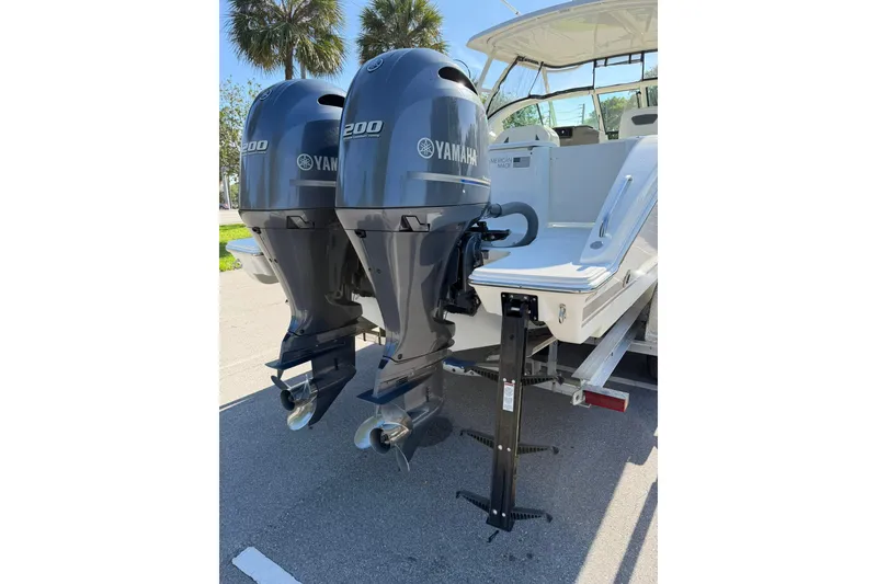 Slide: The Image of 2021 Pursuit DC 266 Dual Console with twin Yamaha 200 engines, parked outdoors. - 10