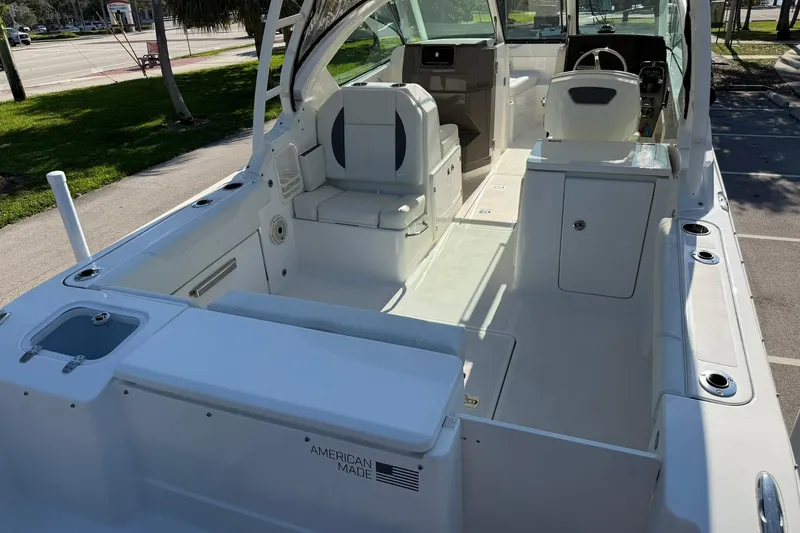 Slide: The Image of 2021 Pursuit DC 266 Dual Console boat interior, showcasing seating and helm area. - 11