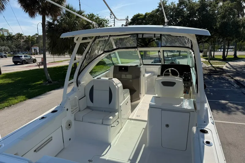 Slide: The Image of 2021 Pursuit DC 266 Dual Console boat interior with seating and steering wheel. - 12