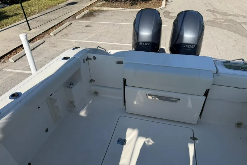 Slide: The Image of 2021 Pursuit DC 266 Dual Console boat with twin Yamaha 200 engines in a parking lot. - 13