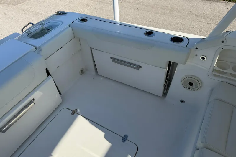Slide: The Image of 2021 Pursuit DC 266 Dual Console boat interior with seating and storage compartments. - 14