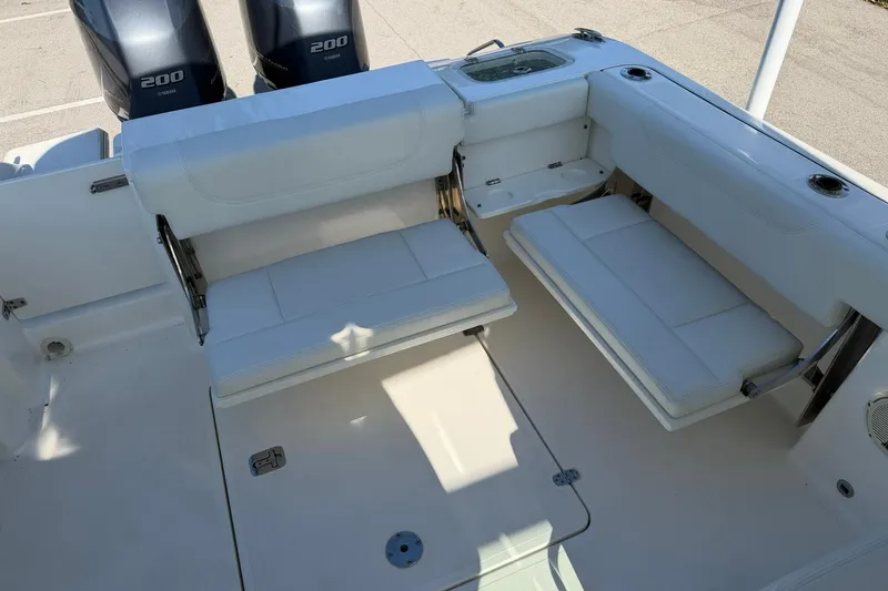 Slide: The Image of 2021 Pursuit DC 266 Dual Console boat interior with seating and twin Yamaha 200 engines. - 15