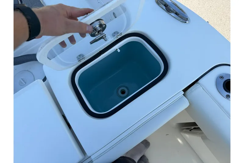 Slide: The Image of 2021 Pursuit DC 266 Dual Console boat with open storage compartment. - 16
