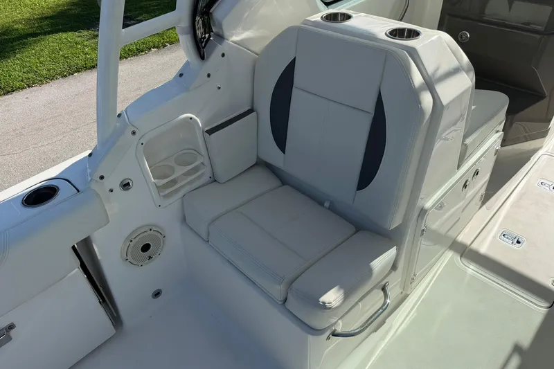 Slide: The Image of 2021 Pursuit DC 266 Dual Console boat seat with cup holders and storage. - 18