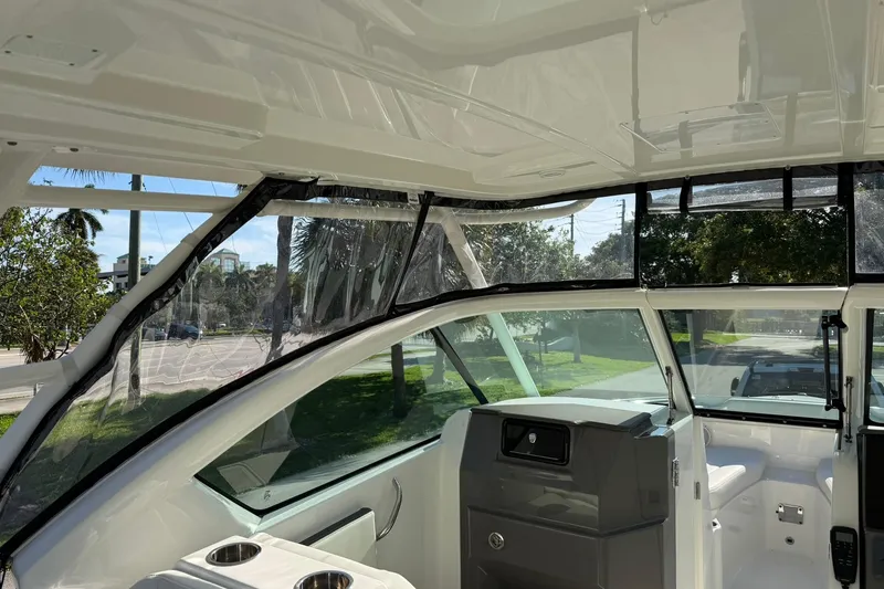 Slide: The Image of 2021 Pursuit DC 266 Dual Console interior with clear windows and sleek design. - 24