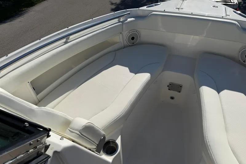 Slide: The Image of 2021 Pursuit DC 266 Dual Console boat interior with white cushioned seating. - 26
